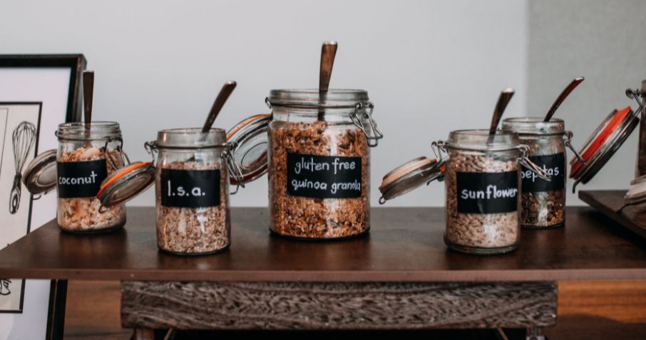clear-glass-jars-on-a-brown-wooden-table-with-labels