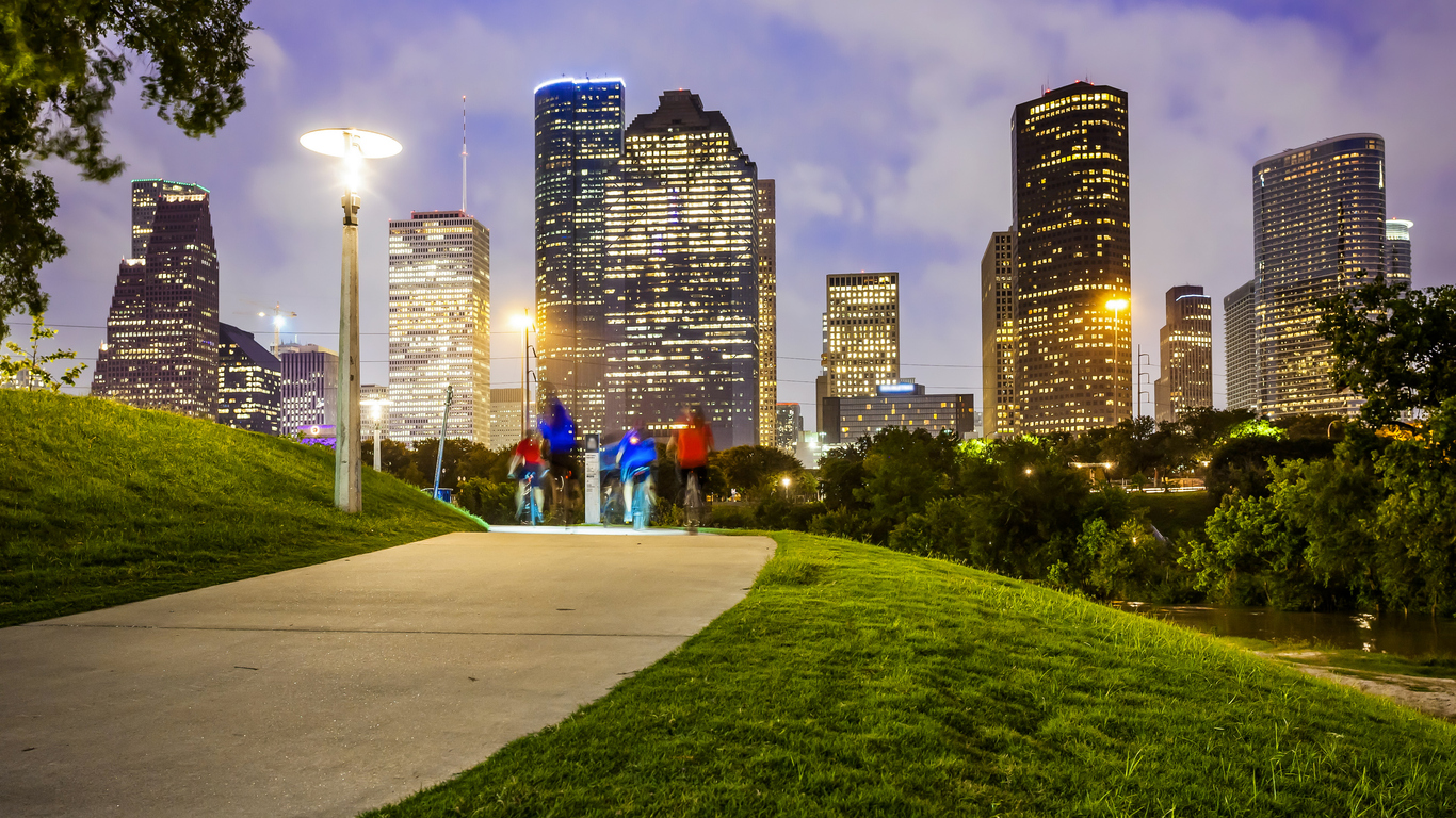 Houston city skyline at night & people in park
