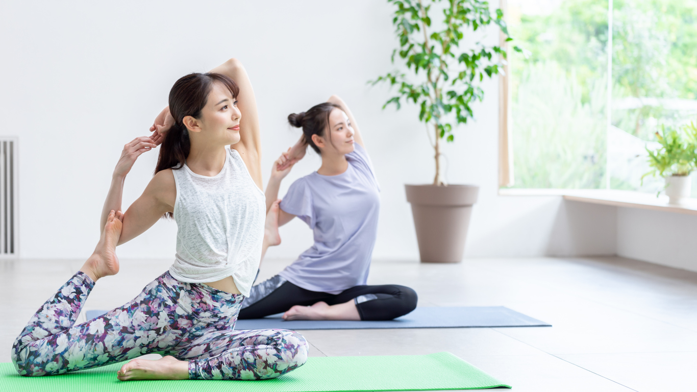 Two Japanese women doing Yoga.