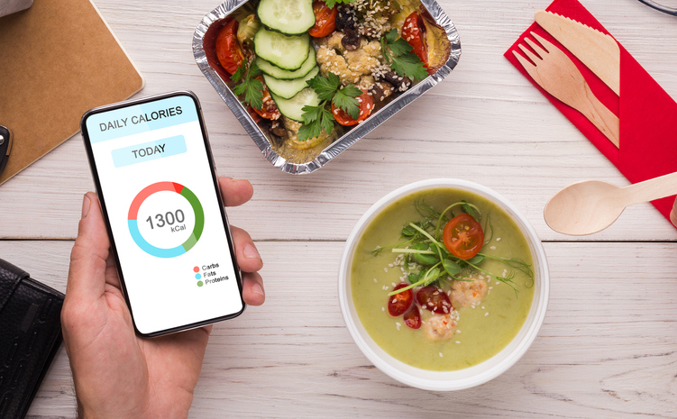 Healthy Eating. Man Using Calories Counting App On Smartphone And Having Lunch