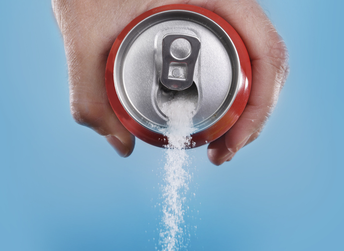 hand holding soda can pouring in metaphor of sugar content