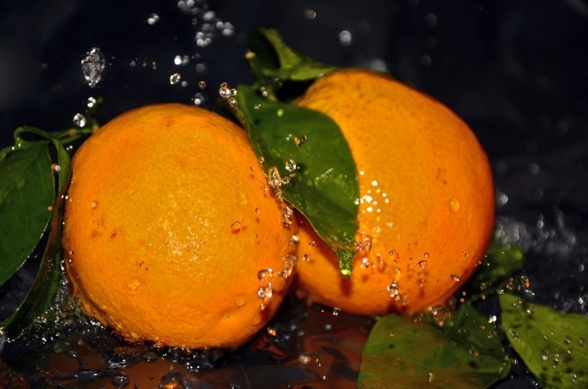 water splashes on two oranges
