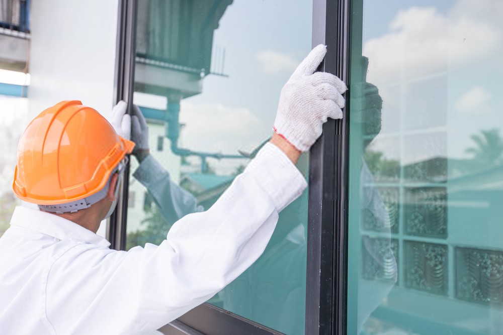 worker replacing window glass