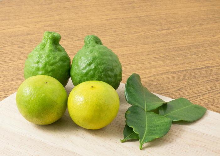 Green Kaffir Lime with Lemon Lime on Cutting Board