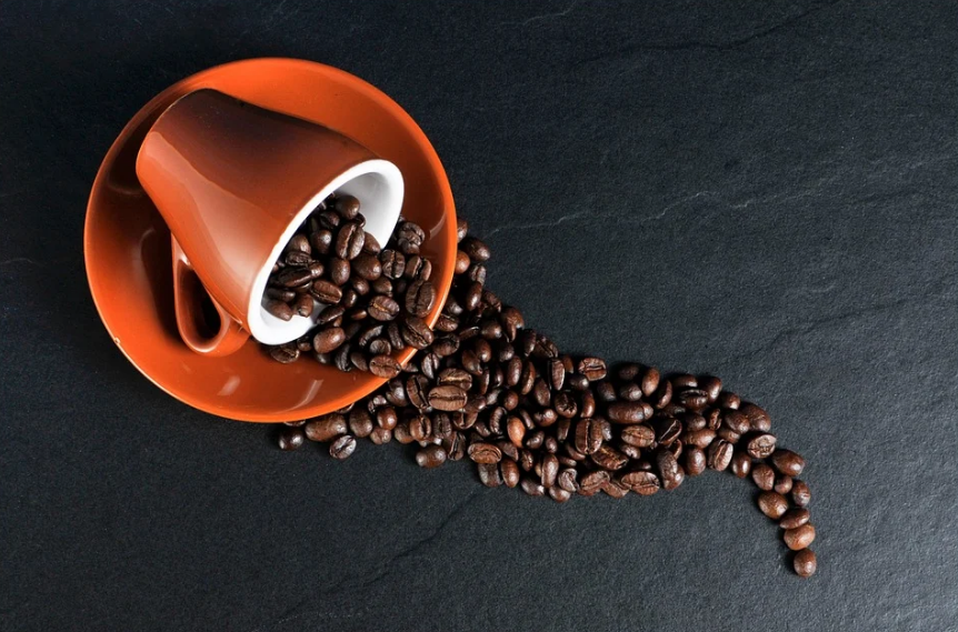 coffee beans that spilled from a cup