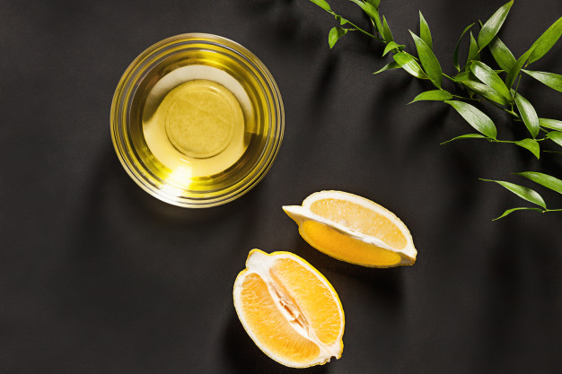 lemon-oil-isolated-black-table