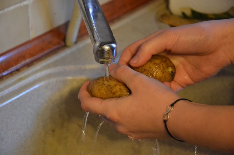 person-washing-potatoes